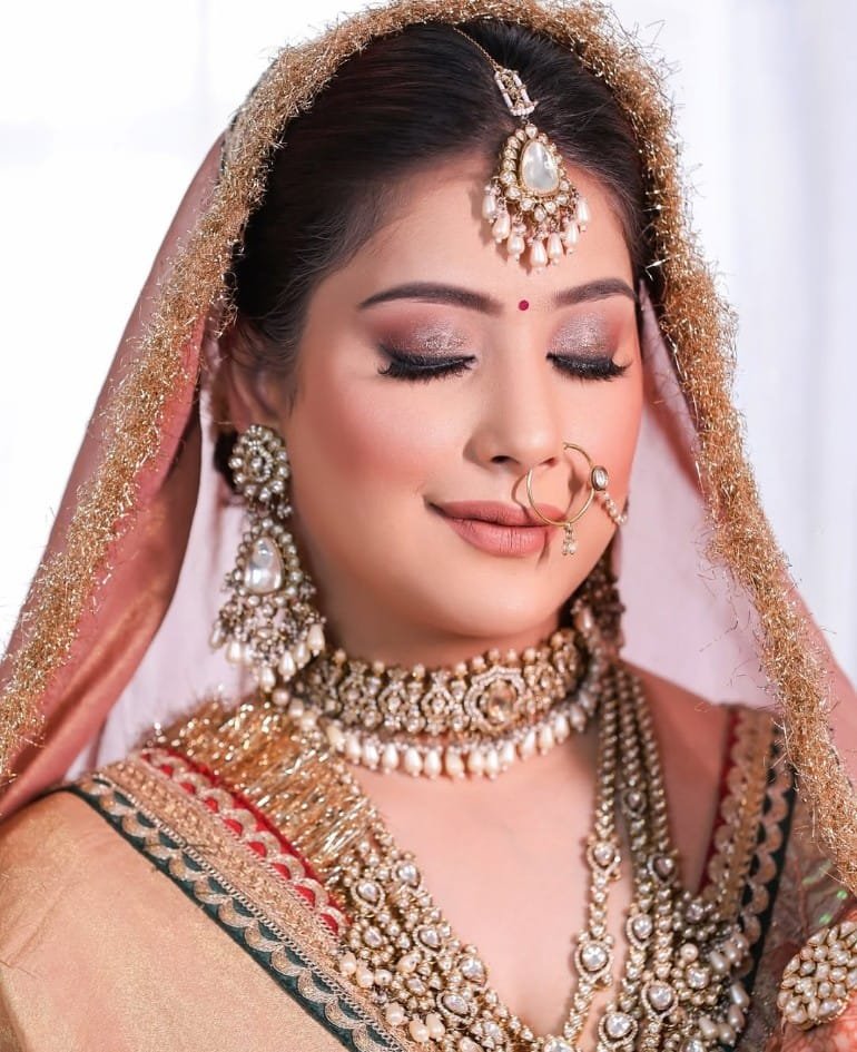 Bridal portrait with dusty rose dupatta, nath and layered pearl-gold jewellery